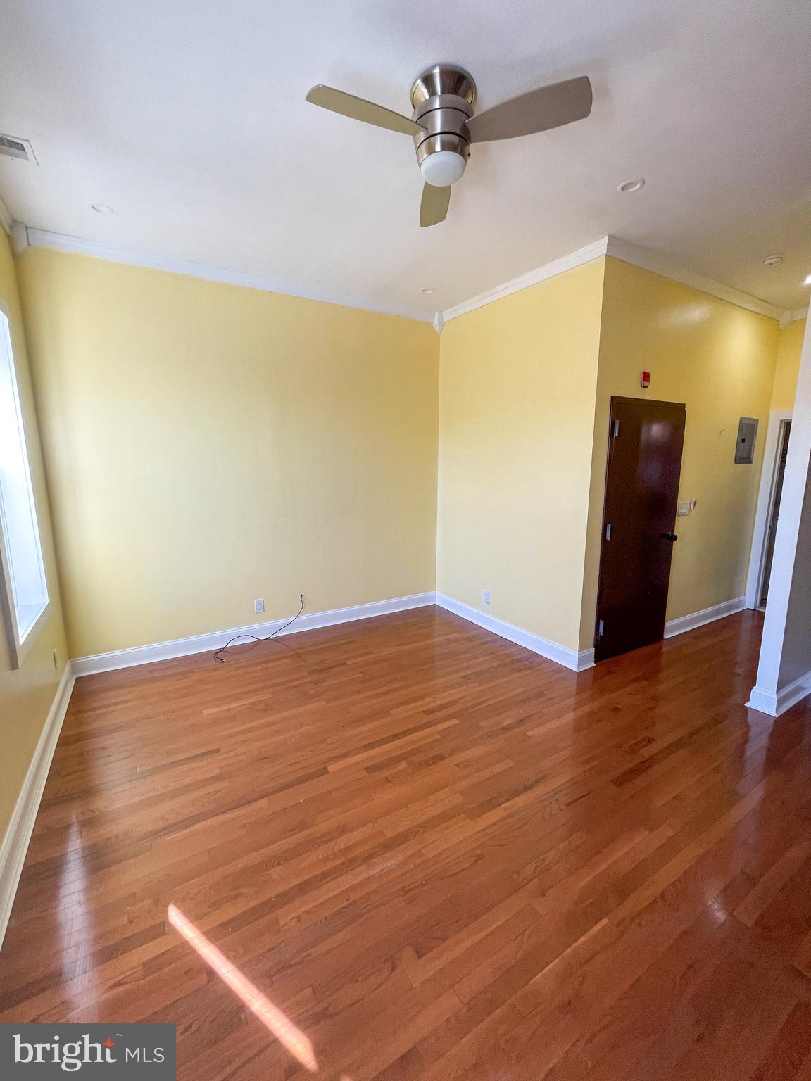 122 North 53rd Street Philadelphia, PA 19139 - Photo 6 of 11 a view of a room with wooden floor and a ceiling fan
