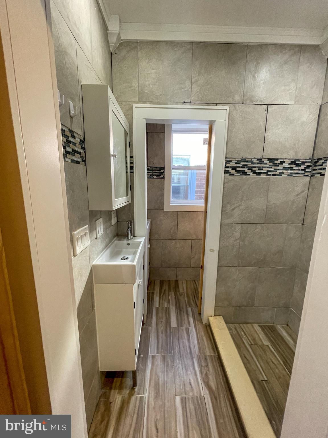 122 North 53rd Street Philadelphia, PA 19139 - Photo 7 of 11 a bathroom with a sink and mirror