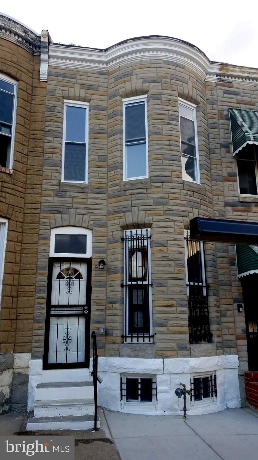 a front view of a house with large windows