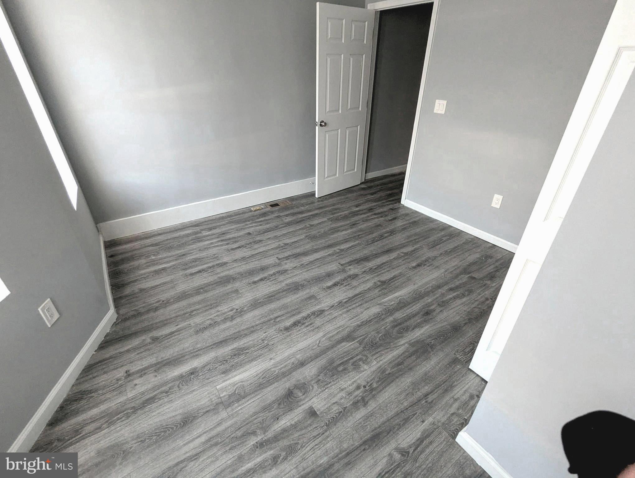 626 North Payson Street Baltimore, MD 21217 - Photo 11 of 23 wooden floor in an empty room with a window