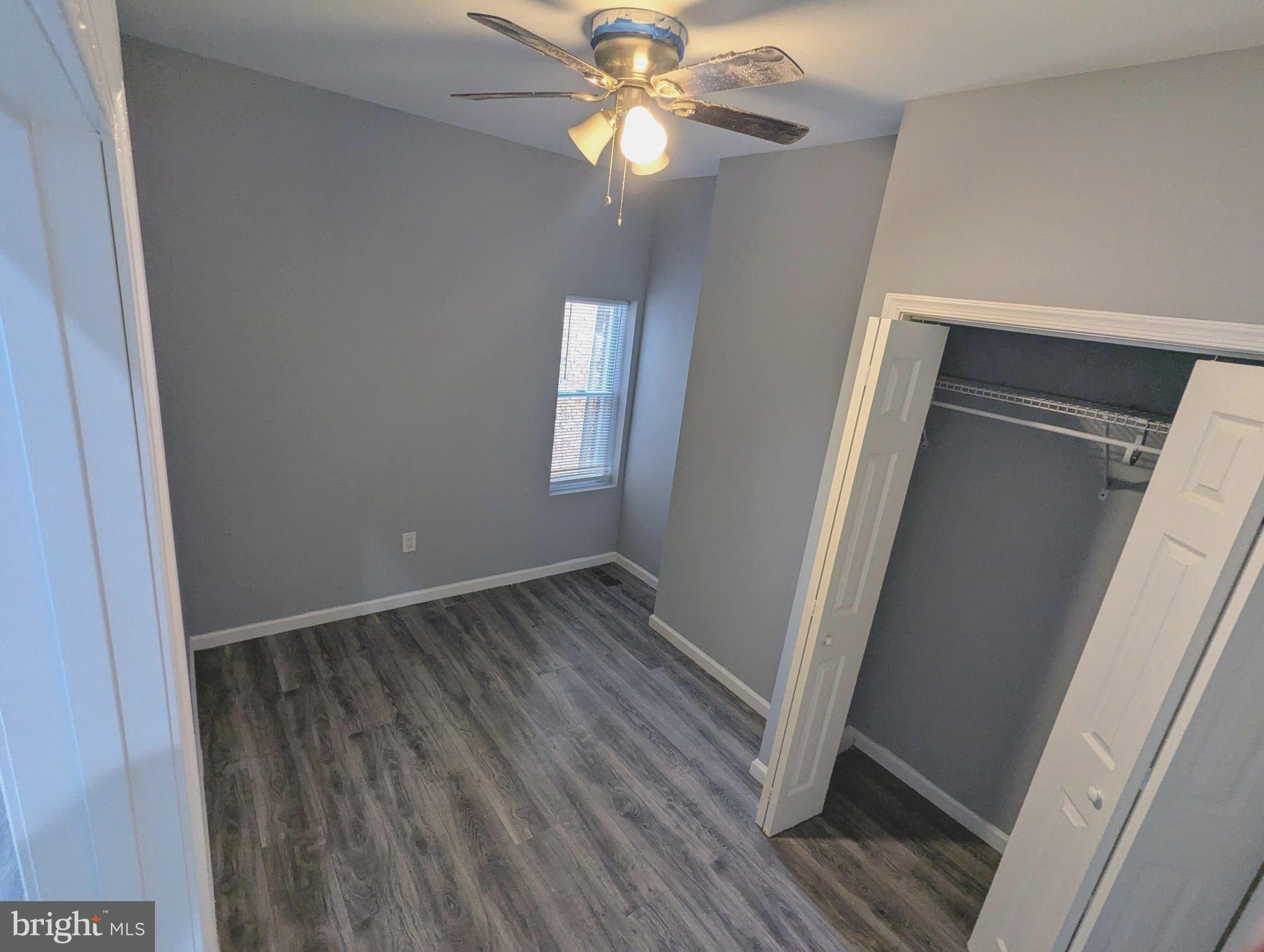 626 North Payson Street Baltimore, MD 21217 - Photo 12 of 23 a view of an empty room with wooden floor and a window