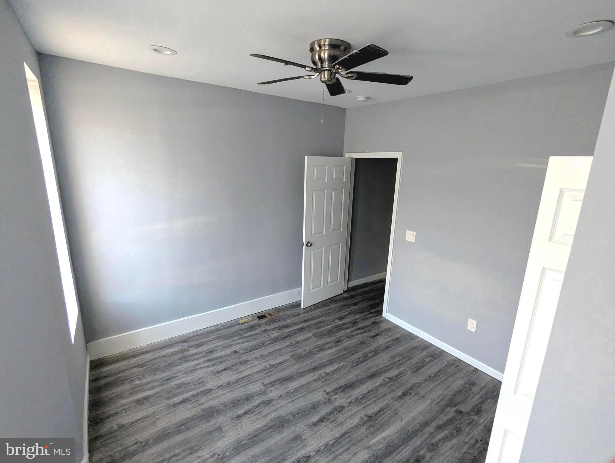 626 North Payson Street Baltimore, MD 21217 - Photo 15 of 23 an empty room with wooden floor and a ceiling fan