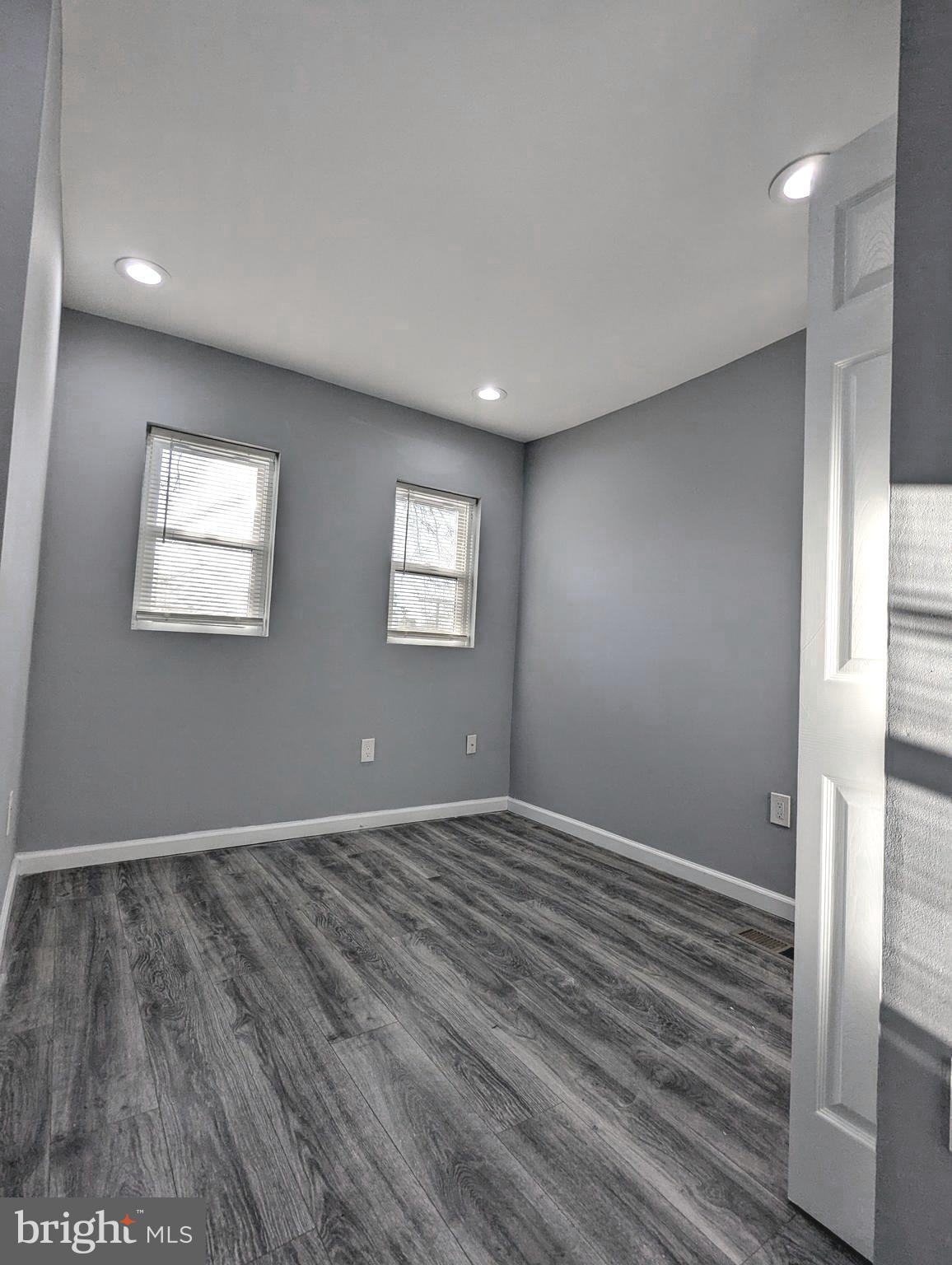 626 North Payson Street Baltimore, MD 21217 - Photo 16 of 23 a view of an empty room with wooden floor and a window