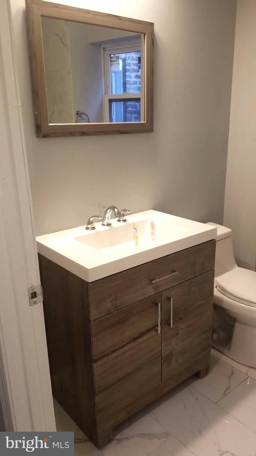626 North Payson Street Baltimore, MD 21217 - Photo 18 of 23 a bathroom with a sink vanity and toilet