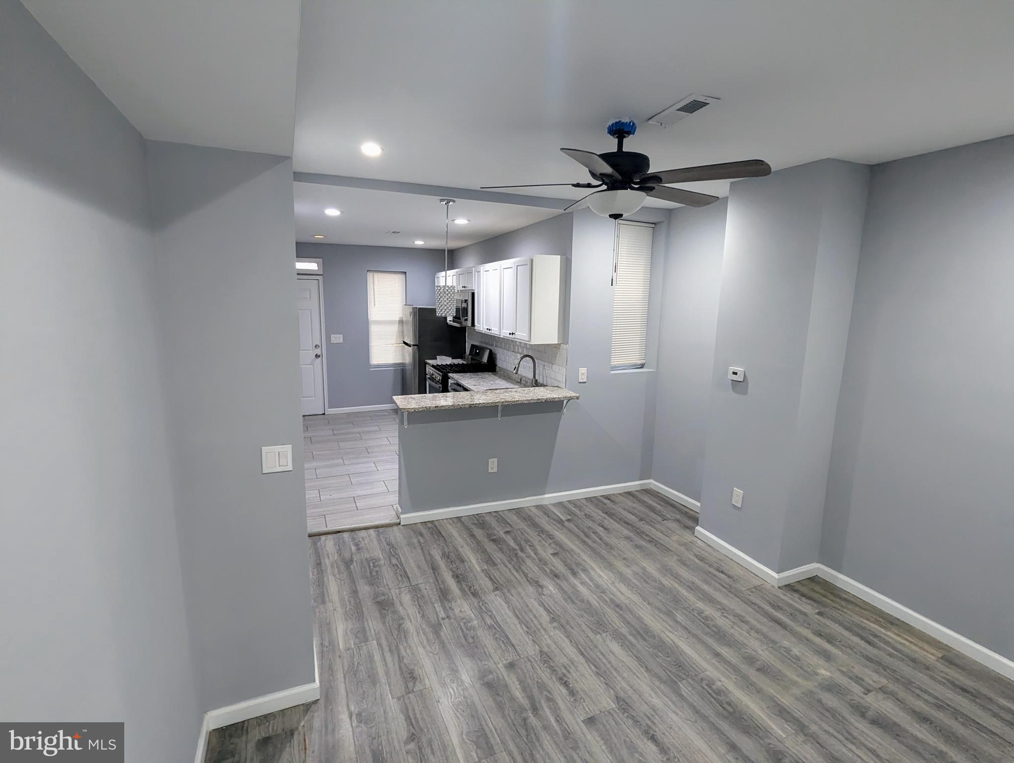 626 North Payson Street Baltimore, MD 21217 - Photo 4 of 23 a view of a kitchen with a sink and cabinet with a ceiling fan