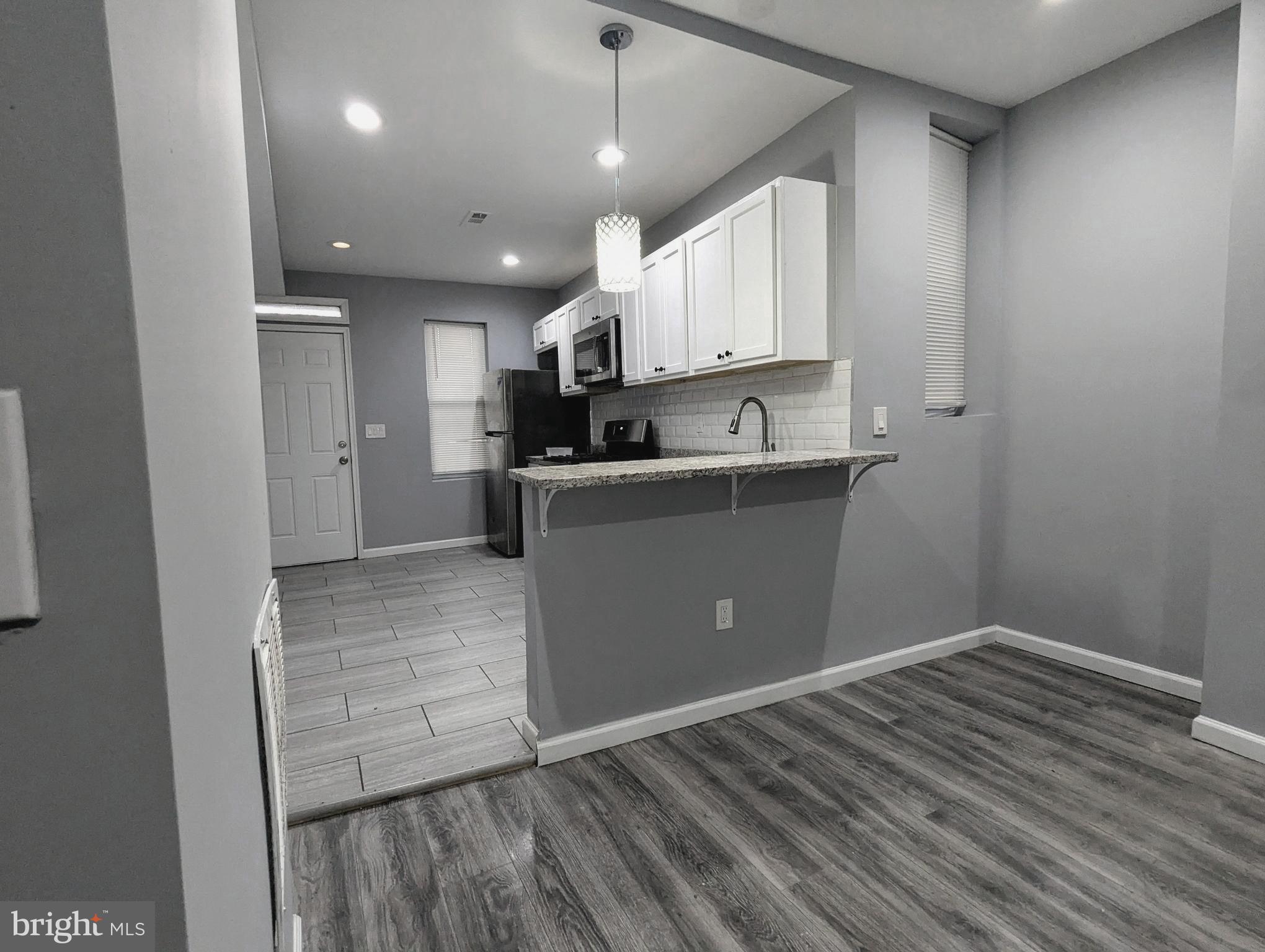 626 North Payson Street Baltimore, MD 21217 - Photo 5 of 23 a kitchen with stainless steel appliances a refrigerator and a stove top oven