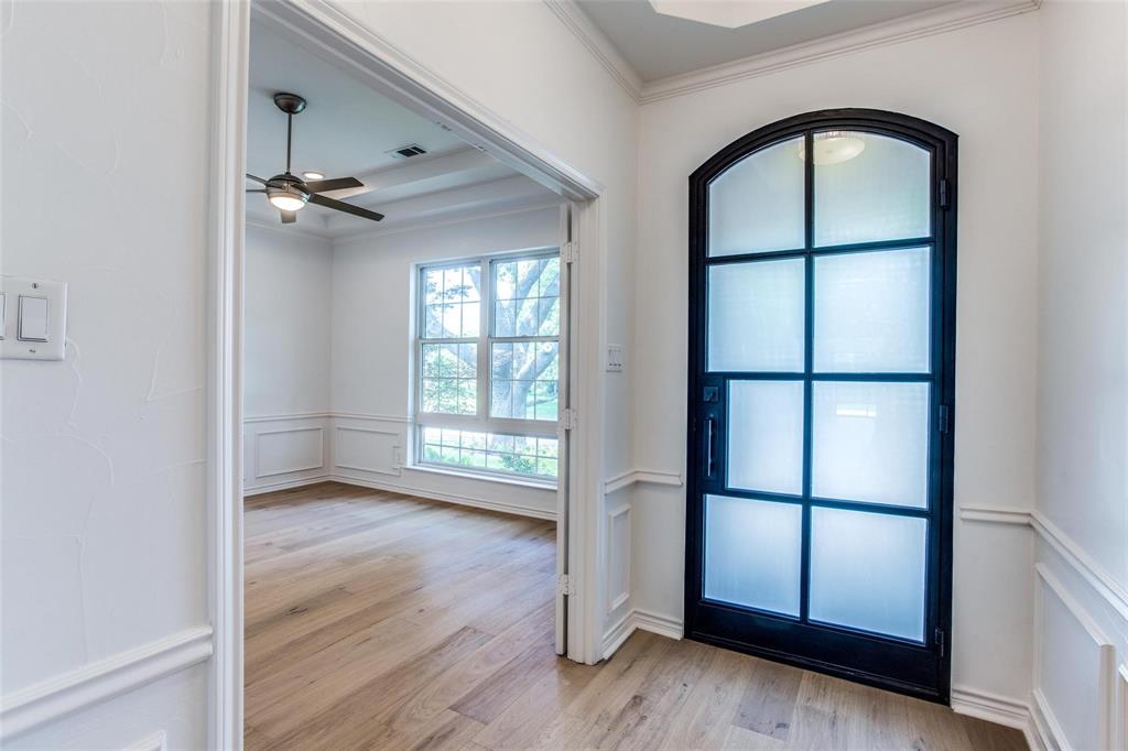 6926 Northwood Road Dallas, TX 75225 - Photo 3 of 29 an empty room with wooden floor fan and windows