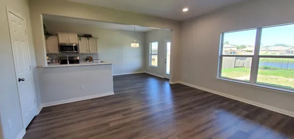 a view of a kitchen with wooden floor and a sink