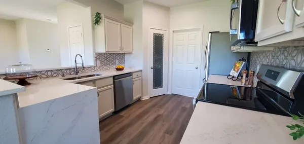 a kitchen with a sink stove and cabinets