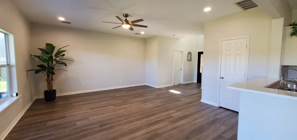 a view of an empty room and wooden floor