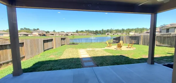 a view of a house with backyard and sitting area