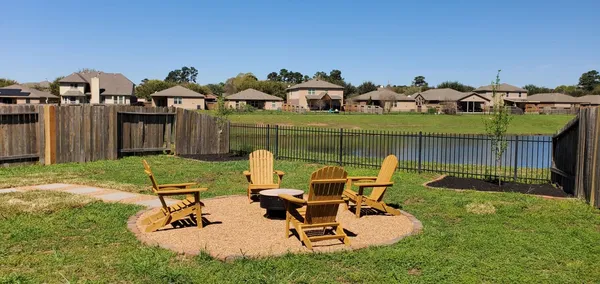 a view of a backyard with a patio and lake view