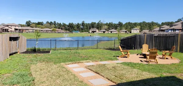 a view of an house with backyard space and chairs