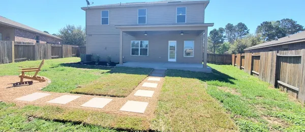 a view of a lake with a deck and a yard