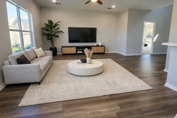 a living room with furniture and a flat screen tv