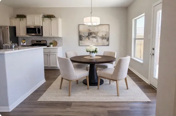 a dining room with furniture and window