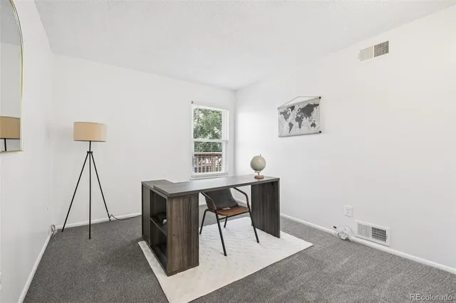 a view of a workspace with furniture