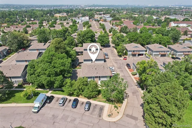 an aerial view of a house with a yard and lake view
