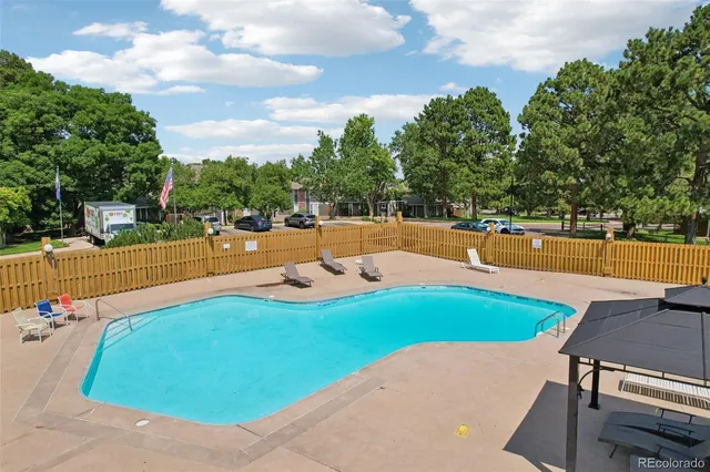 an outdoor space with pool and furniture