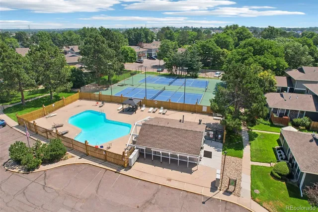 an aerial view of a house with swimming pool garden and patio