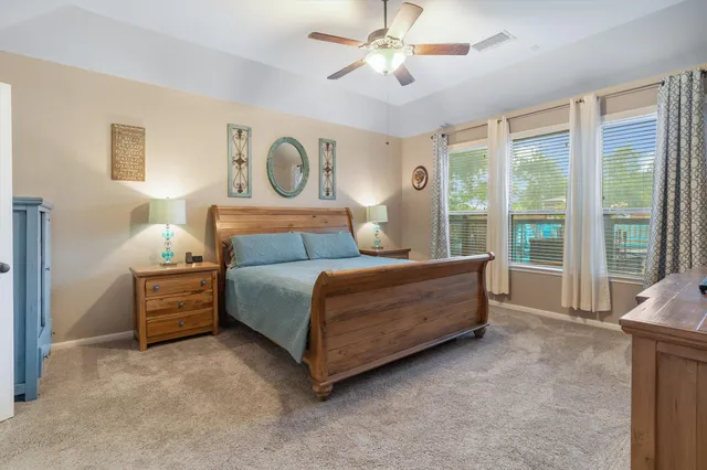 a bedroom with a bed and a large window