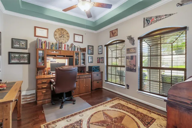 a view of a livingroom with workspace and a window