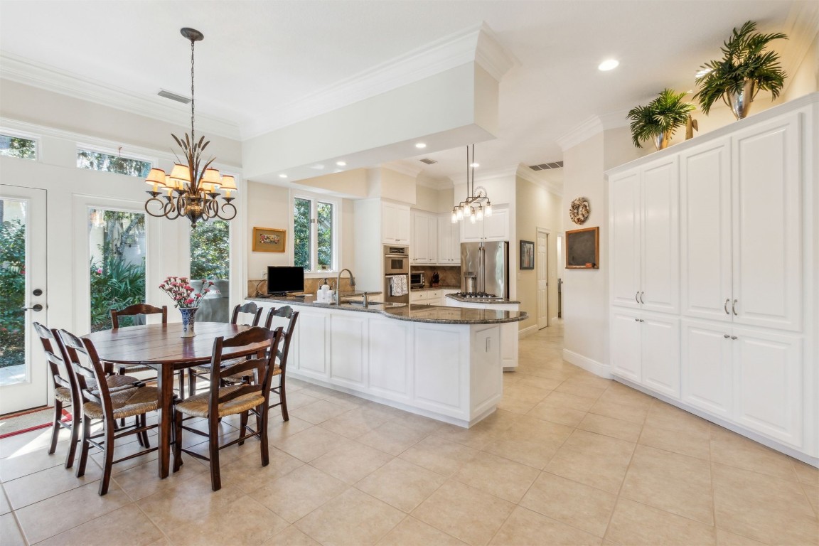 10 Marsh Creek Road Amelia Island, FL 32034 - Photo 13 of 73 a view of a dining room and livingroom with furniture wooden floor a chandelier