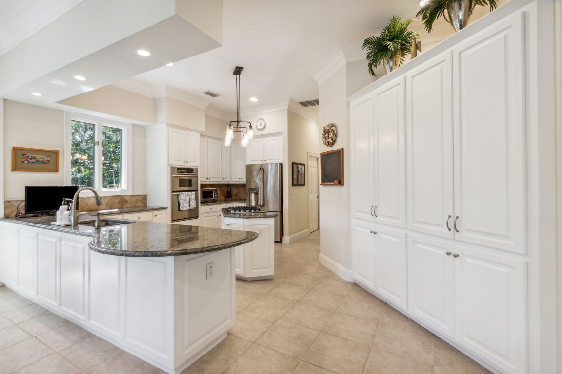 10 Marsh Creek Road Amelia Island, FL 32034 - Photo 16 of 73 a kitchen with stainless steel appliances granite countertop a refrigerator and a sink