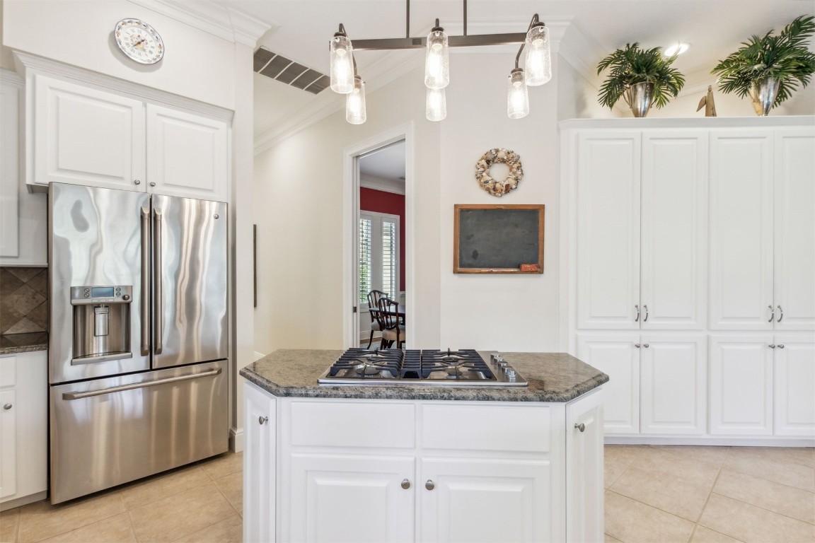 10 Marsh Creek Road Amelia Island, FL 32034 - Photo 17 of 73 a kitchen with stainless steel appliances granite countertop a refrigerator a stove and white cabinets