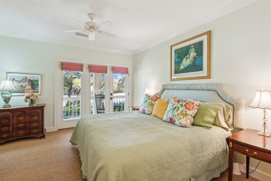 10 Marsh Creek Road Amelia Island, FL 32034 - Photo 29 of 73 a bedroom with a large bed and a chandelier