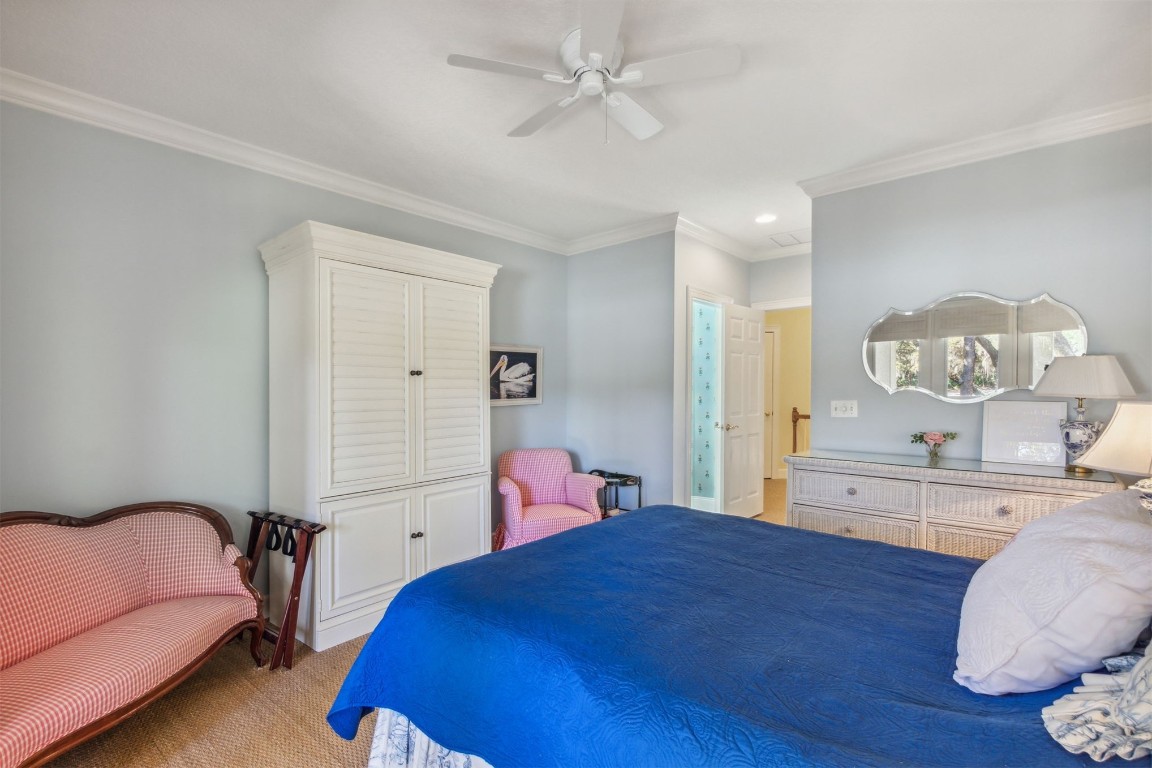 10 Marsh Creek Road Amelia Island, FL 32034 - Photo 33 of 73 a bedroom with a bed and dresser with mirror
