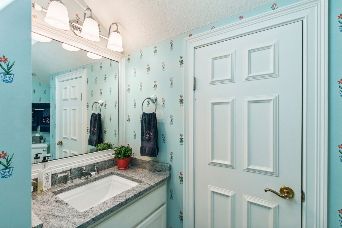 10 Marsh Creek Road Amelia Island, FL 32034 - Photo 35 of 73 a bathroom with a granite countertop sink and a mirror