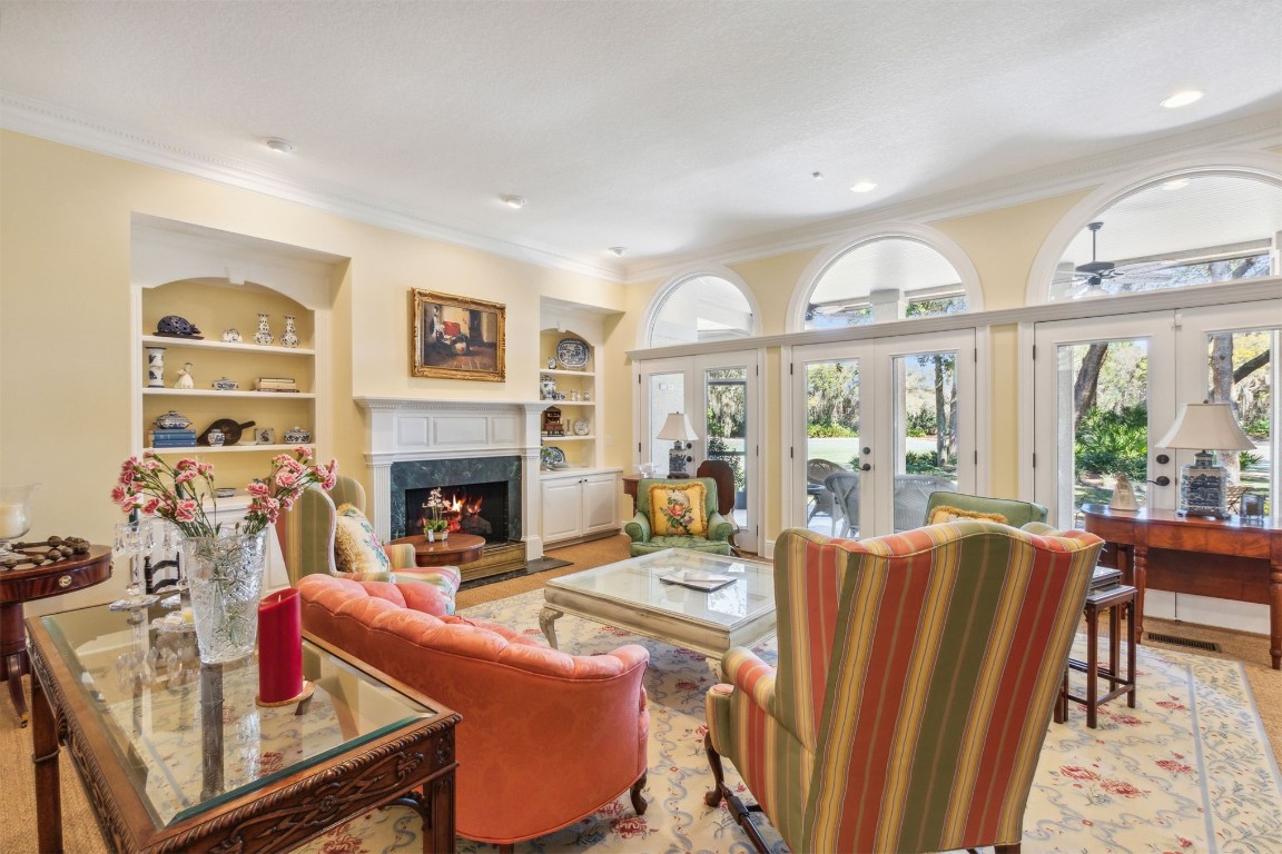 10 Marsh Creek Road Amelia Island, FL 32034 - Photo 7 of 73 a living room with furniture a fireplace and a large window