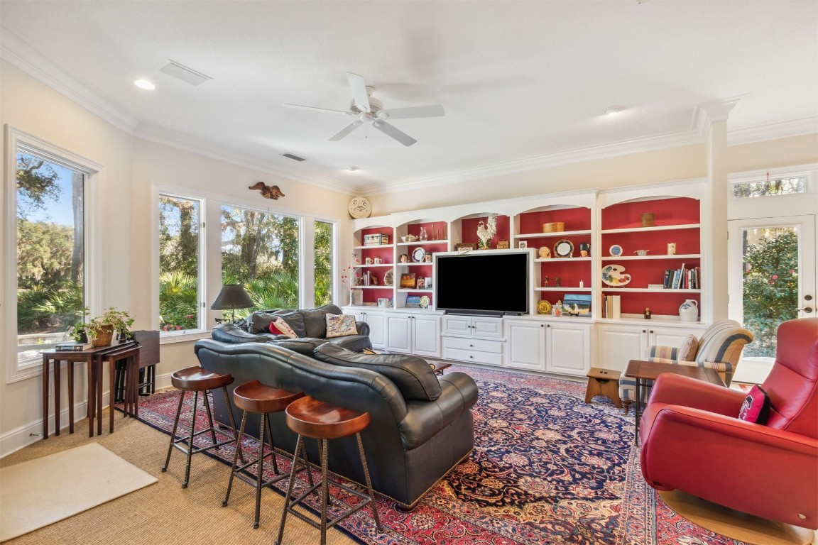 10 Marsh Creek Road Amelia Island, FL 32034 - Photo 10 of 73 a living room with furniture a flat screen tv and a large window