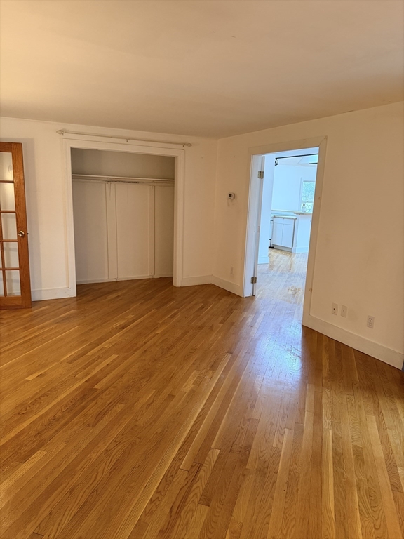 1 Nevada Road Burlington, MA 01803 - Photo 12 of 21 an empty room with wooden floor and windows