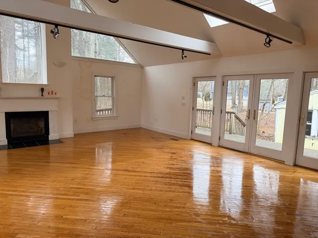 a view of a kitchen with wooden floor and cabinets