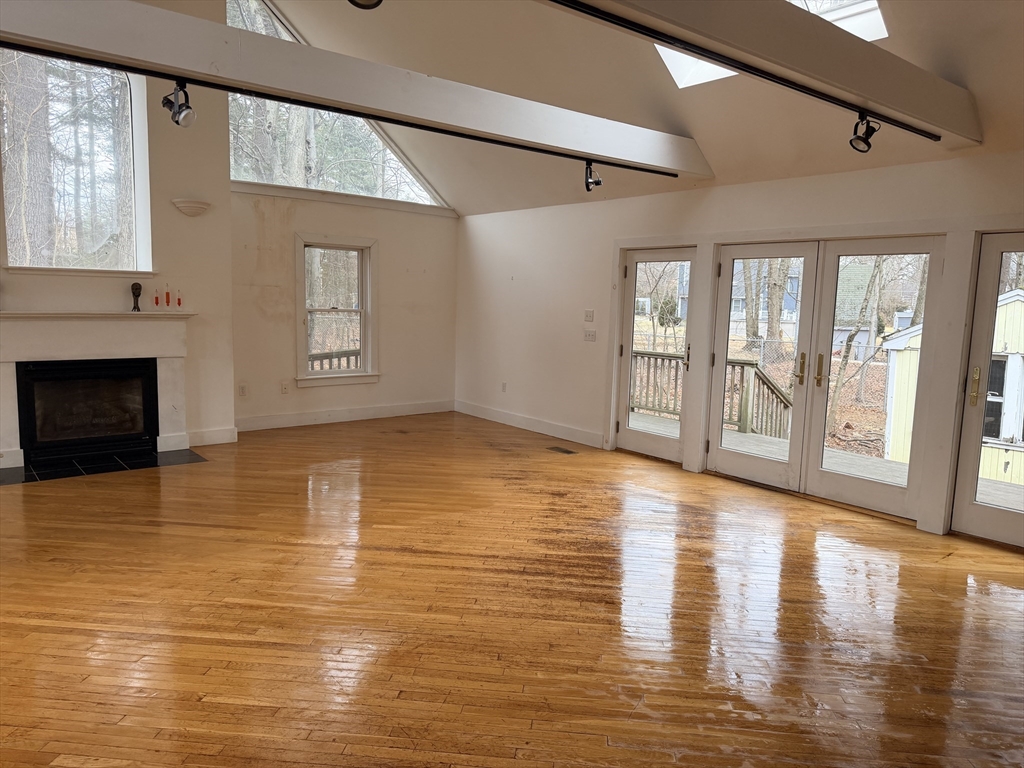 1 Nevada Road Burlington, MA 01803 - Photo 14 of 21 a view of an empty room with window and wooden floor