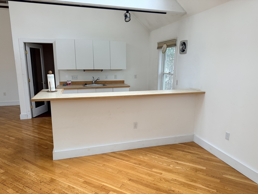 1 Nevada Road Burlington, MA 01803 - Photo 15 of 21 a view of a kitchen with wooden floor and cabinets