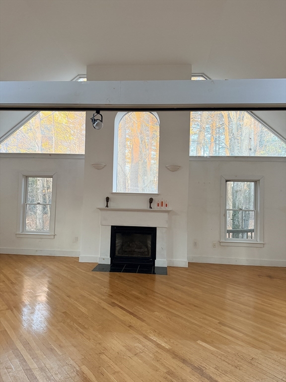 1 Nevada Road Burlington, MA 01803 - Photo 16 of 21 an empty room with wooden floor fireplace and windows