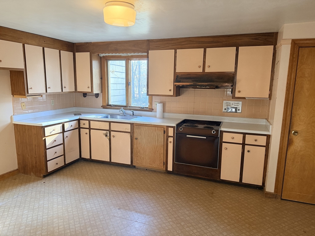 1 Nevada Road Burlington, MA 01803 - Photo 5 of 21 a kitchen with stainless steel appliances granite countertop a stove a sink and a microwave