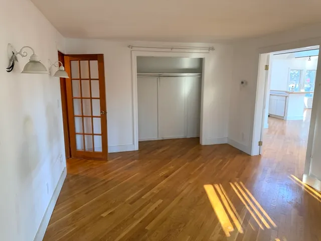 a view of a hardwood floor in an empty room