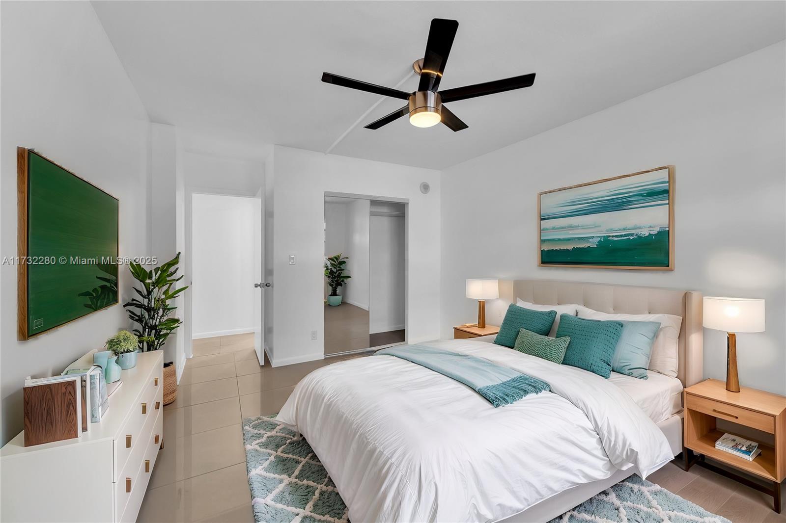 200 South Birch Road, Unit 103 Fort Lauderdale, FL 33316 - Photo 2 of 10 a bedroom with a bed and a potted plant