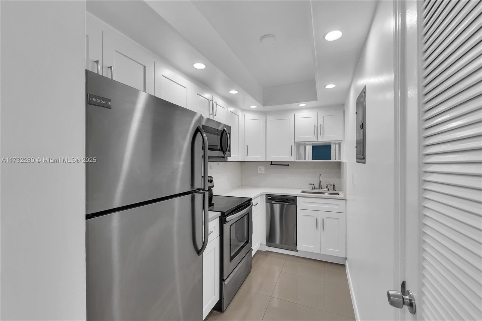 200 South Birch Road, Unit 103 Fort Lauderdale, FL 33316 - Photo 3 of 10 a kitchen with stainless steel appliances a refrigerator a sink and a stove