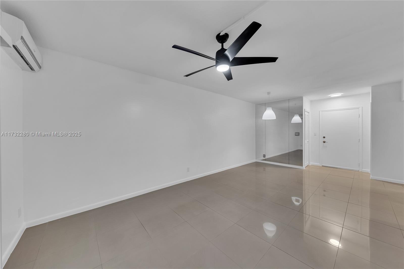 200 South Birch Road, Unit 103 Fort Lauderdale, FL 33316 - Photo 5 of 10 an empty room with a ceiling fan and window