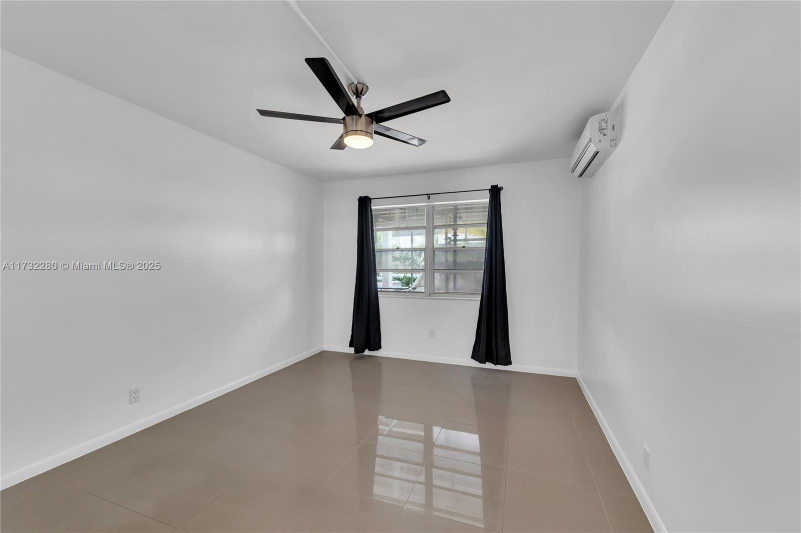 200 South Birch Road, Unit 103 Fort Lauderdale, FL 33316 - Photo 6 of 10 a view of a big room with windows and chandelier fan