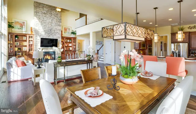 a view of a dining room with furniture a chandelier and wooden floor