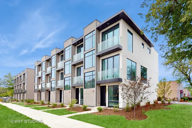 a front view of a building with a yard