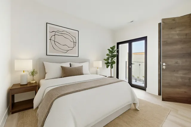 a bedroom with a bed and a painting on the wall