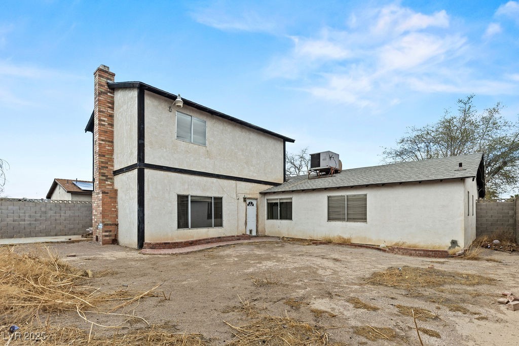 4155 Comb Circle Las Vegas, NV 89104 - Photo 45 of 46 Rear view of house featuring stucco siding, a chim
