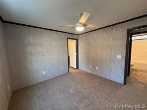 2898 Rte 9W New Windsor, NY 12553 - Photo 7 of 14 Carpeted empty room with a ceiling fan and crown molding